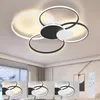 A modern LED ceiling light with multiple rings, shown in a room setting with smaller inset images demonstrating different lighting modes and a remote control.