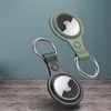 Two Apple AirTag holders with keychains are displayed against a textured background. Produktbild-Vorschau