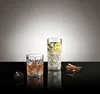 Two glasses of drinks and some cinnamon sticks on a reflective black surface with a gradient background. Produktbild-Vorschau