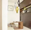 A modern living room with hanging lamps, a side table, and pillows. Produktbild-Vorschau