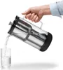 A hand is pouring water from a pitcher into a glass. Náhľad obrázku produktu