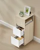 A narrow bedside table with two drawers and an open shelf, displayed in a room setting. Náhled obrázku produktu