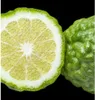 A close-up view of a halved bergamot fruit and a whole bergamot fruit against a black background. Produktbild-Vorschau