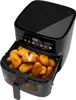 A black air fryer filled with chicken nuggets. Anteprima dell’immagine prodotto