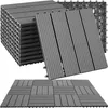 A stack of gray interlocking deck tiles and a few tiles laid out in a pattern. Náhled obrázku produktu