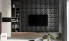 A modern living room with a TV mounted on a textured black wall and a wooden media console. Produktbild-Vorschau