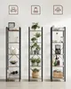 Three tall, narrow bookshelves are arranged side-by-side against a white wall. Each shelf is decorated with various items, including plants, decorative vases, books, and kitchenware. Náhľad obrázku produktu