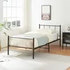A black metal bed frame with bedding in a bedroom setting. Náhľad obrázku produktu