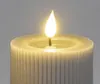 A close-up shot of the top of a white LED candle with a lit flame. Produktbild-Vorschau