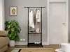 A room with a clothing rack, plant, sofa, and door. Náhľad obrázku produktu
