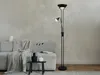 A modern living room corner with a grey sofa, a black floor lamp with a reading light, and decorative items on a small table. Produktbild-Vorschau