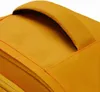 A close-up view of the top handle and fabric of a yellow backpack. Produktbild-Vorschau