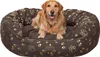 A golden retriever dog is lying on a brown dog bed with paw print patterns. Podgląd zdjęcia produktu
