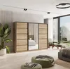 A bedroom scene featuring a large wardrobe with mirrored doors, a plant, and seating. Produktbild-Vorschau