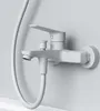 A white bathtub faucet mounted on a light gray wall. Produktbild-Vorschau