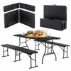 A black folding picnic table and bench set is displayed, with some food items on the table. Produktbild-Vorschau