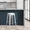 A white metal bar stool is shown in a kitchen setting. Náhľad obrázku produktu