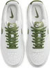 A top-down view of a pair of white Nike Court Vision Low sneakers with green laces and accents. Produktbild-Vorschau