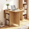A wooden folding table with shelves and a drawer, set up in a room with a bookshelf and a laptop on it. Náhľad obrázku produktu