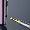 Close-up of a 3.5mm audio jack plug with the UGREEN logo, next to a part of a device with a purple screen. Produktbild-Vorschau