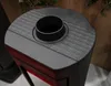Close-up view of the top of a black wood-burning stove. Náhľad obrázku produktu