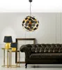 A living room scene with a chandelier, lamps, and a sofa. Podgląd zdjęcia produktu