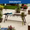 A decorative metal garden bench with a hat on it, placed on a patio with potted plants. Anteprima dell’immagine prodotto
