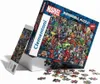 A Marvel-themed jigsaw puzzle box with some puzzle pieces scattered in front. Náhled obrázku produktu