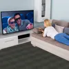 A woman is lying on a couch watching TV, while a couple in 3D glasses watches a movie on the TV screen. Náhled obrázku produktu