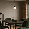 A dining room with a table, chairs, and a pendant light. Náhled obrázku produktu