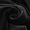 A close-up view of black, soft, textured fabric, likely a garment or blanket, with folds and creases. Podgląd zdjęcia produktu