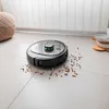 A robot vacuum cleaner is cleaning up spilled pet food on a tiled floor. Náhled obrázku produktu