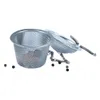 A metal tea strainer with a chain and some peppercorns on a white background. Produktbild-Vorschau