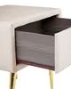 Close-up of a beige velvet nightstand with a partially open drawer and gold legs. Náhľad obrázku produktu