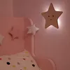 A child's bedroom with a pink bed and star-shaped decorations. Náhled obrázku produktu