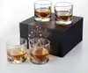 Four whiskey glasses filled with amber liquid are arranged around a black product box. Produktbild-Vorschau