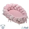 A pink braided baby nest with a pillow and a bow on a white background. Náhled obrázku produktu