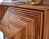 A close-up view of a wooden sideboard with a slatted door design. Náhled obrázku produktu