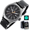 A Timex Expedition watch is shown in a studio setting with a black leather strap and a black dial. A smaller inset image shows the watch face glowing in the dark, and another inset shows the watch in its presentation box. Produktbild-Vorschau