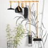 Cleaning tools displayed on a wall with a bamboo-themed mural. Náhled obrázku produktu