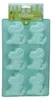 A light blue silicone muffin mold in the shape of dinosaurs, with packaging at the top. Náhled obrázku produktu