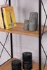 A close-up view of a bookshelf with books and decorative owl figures. Produktbild-Vorschau