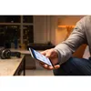 A person holding a smartphone in a dimly lit room. Anteprima dell’immagine prodotto