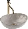 A close-up studio shot of a marble sink with a gold faucet. Podgląd zdjęcia produktu