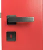 A close-up view of a red door with a modern anthracite door handle and keyhole plate. Produktbild-Vorschau