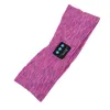 A purple and pink heathered headband with a small black control module attached. Náhled obrázku produktu