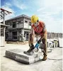 A construction worker is using an angle grinder to cut concrete blocks on a construction site. Produktbild-Vorschau