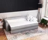 A sofa bed with a mattress topper and pillows in a room with paneled walls. Produktbild-Vorschau