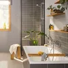 A modern bathroom with a bathtub, shower, and plant. Anteprima dell’immagine prodotto