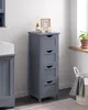 A gray bathroom cabinet with four drawers stands against a white wall, next to a sink. Náhled obrázku produktu